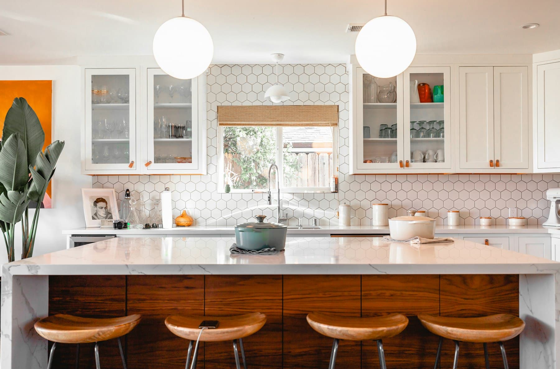 Modular kitchen with marble counters and warm cabinetry